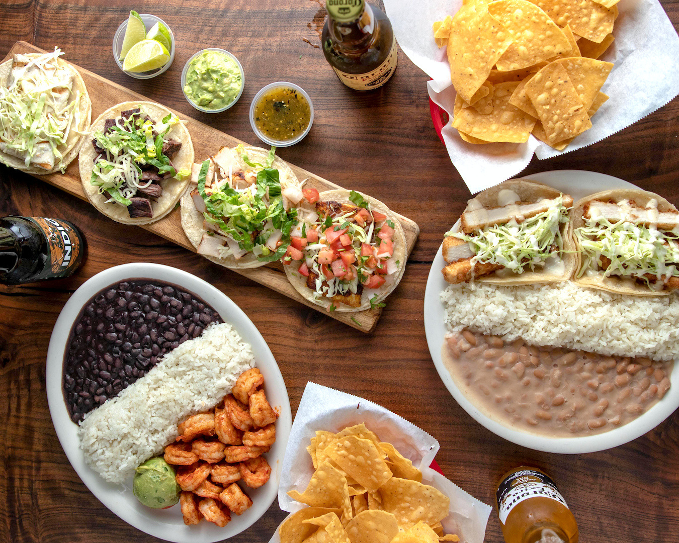 A Baja spread of tacos, shrimp, rice, beans, chips, salsa and guacamole